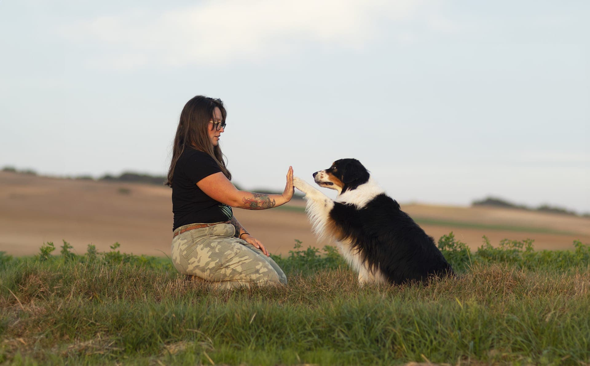 Océane et un de ses bergers australien partageant un contact main-patte
